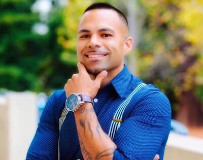 Headshot of Cris Gomez, smiling in a blue shirt.