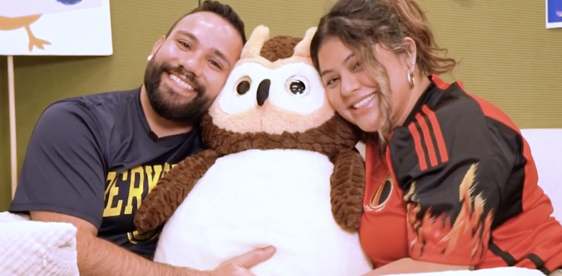 A smiling Leo (left) and Zuleika (right) embrace a large, fluffy Owlbert (Re-entry Student Program's mascot).